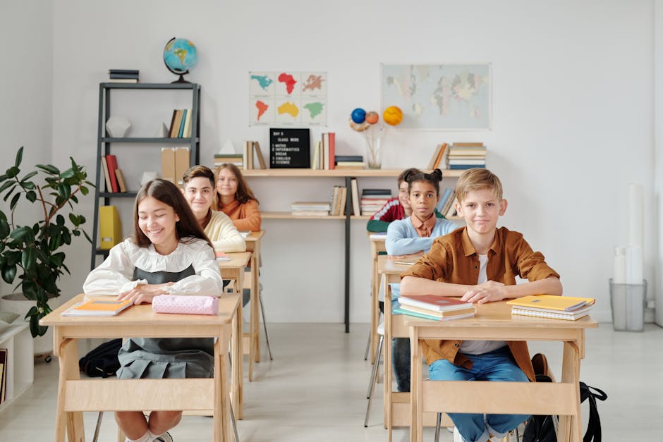 A group of happy students sitting at desks in a modern classroom environment